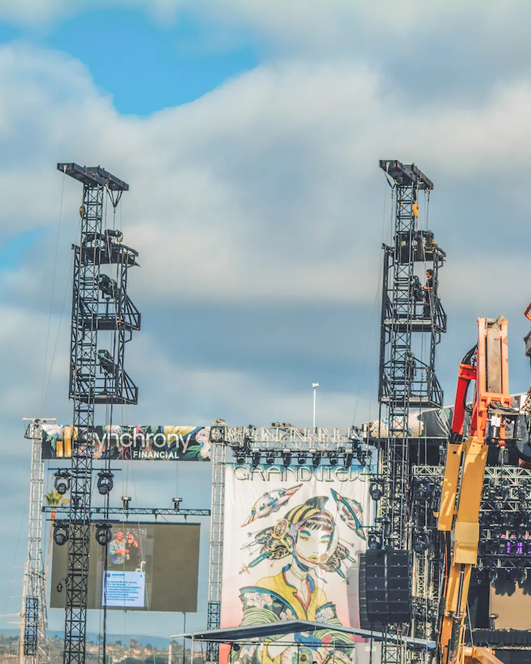 A festival main stage under construction, cranes still on site.